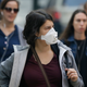 A woman wears a mask in San Francisco Friday. The air quality there is currently unhealthy.
